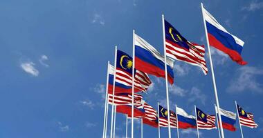 Malaysia and Russia Flags Waving Together in the Sky, Seamless Loop in Wind, Space on Left Side for Design or Information, 3D Rendering video