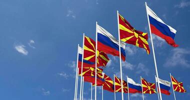 norte Macedônia e Rússia bandeiras acenando juntos dentro a céu, desatado ciclo dentro vento, espaço em esquerda lado para Projeto ou Informação, 3d Renderização video