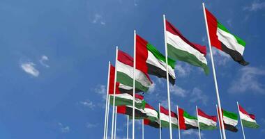 Hungria e Unidos árabe emirados, eua bandeiras acenando juntos dentro a céu, desatado ciclo dentro vento, espaço em esquerda lado para Projeto ou Informação, 3d Renderização video