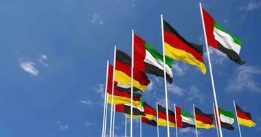 Alemania y unido árabe emiratos, uae banderas ondulación juntos en el cielo, sin costura lazo en viento, espacio en izquierda lado para diseño o información, 3d representación video