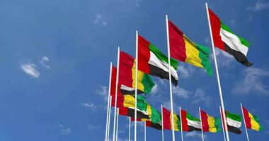 Guinea and United Arab Emirates, UAE Flags Waving Together in the Sky, Seamless Loop in Wind, Space on Left Side for Design or Information, 3D Rendering video