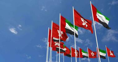 Hong Kong and United Arab Emirates, UAE Flags Waving Together in the Sky, Seamless Loop in Wind, Space on Left Side for Design or Information, 3D Rendering video