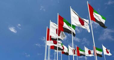 Japón y unido árabe emiratos, uae banderas ondulación juntos en el cielo, sin costura lazo en viento, espacio en izquierda lado para diseño o información, 3d representación video