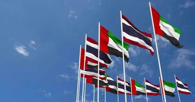 Thailand and United Arab Emirates, UAE Flags Waving Together in the Sky, Seamless Loop in Wind, Space on Left Side for Design or Information, 3D Rendering video