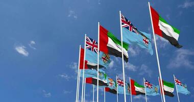 Fiji and United Arab Emirates, UAE Flags Waving Together in the Sky, Seamless Loop in Wind, Space on Left Side for Design or Information, 3D Rendering video