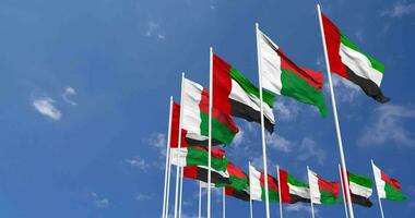 Madagáscar e Unidos árabe emirados, eua bandeiras acenando juntos dentro a céu, desatado ciclo dentro vento, espaço em esquerda lado para Projeto ou Informação, 3d Renderização video