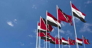 Trinidad and Tobago and Yemen Flags Waving Together in the Sky, Seamless Loop in Wind, Space on Left Side for Design or Information, 3D Rendering video