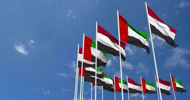 United Arab Emirates and Yemen Flags Waving Together in the Sky, Seamless Loop in Wind, Space on Left Side for Design or Information, 3D Rendering video