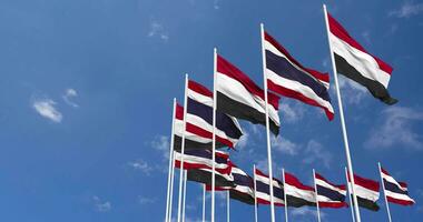 Thailand and Yemen Flags Waving Together in the Sky, Seamless Loop in Wind, Space on Left Side for Design or Information, 3D Rendering video
