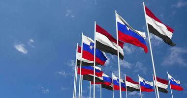 Slovenia and Yemen Flags Waving Together in the Sky, Seamless Loop in Wind, Space on Left Side for Design or Information, 3D Rendering video