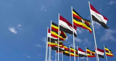 Uganda e Iémen bandeiras acenando juntos dentro a céu, desatado ciclo dentro vento, espaço em esquerda lado para Projeto ou Informação, 3d Renderização video