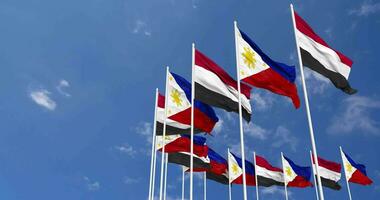 philippines et Yémen drapeaux agitant ensemble dans le ciel, sans couture boucle dans vent, espace sur la gauche côté pour conception ou information, 3d le rendu video