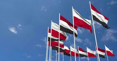 Poland and Yemen Flags Waving Together in the Sky, Seamless Loop in Wind, Space on Left Side for Design or Information, 3D Rendering video