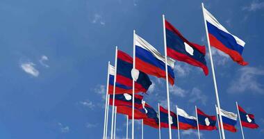 Laos and France Flags Waving Together in the Sky, Seamless Loop in Wind, Space on Left Side for Design or Information, 3D Rendering video