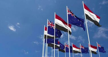 New Zealand and Yemen Flags Waving Together in the Sky, Seamless Loop in Wind, Space on Left Side for Design or Information, 3D Rendering video