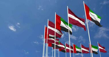 Latvia and United Arab Emirates, UAE Flags Waving Together in the Sky, Seamless Loop in Wind, Space on Left Side for Design or Information, 3D Rendering video