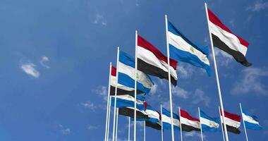 Nicaragua and Yemen Flags Waving Together in the Sky, Seamless Loop in Wind, Space on Left Side for Design or Information, 3D Rendering video