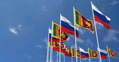sri Lanka und Russland Flaggen winken zusammen im das Himmel, nahtlos Schleife im Wind, Raum auf links Seite zum Design oder Information, 3d Rendern video