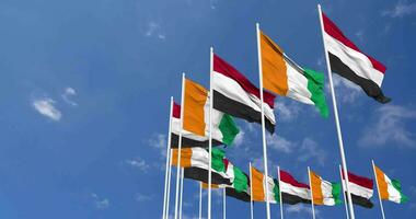 Ivory Coast and Yemen Flags Waving Together in the Sky, Seamless Loop in Wind, Space on Left Side for Design or Information, 3D Rendering video