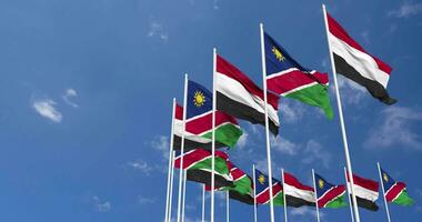 Namibia and Yemen Flags Waving Together in the Sky, Seamless Loop in Wind, Space on Left Side for Design or Information, 3D Rendering video