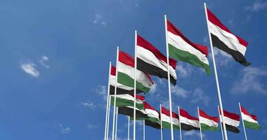 Hungary and Yemen Flags Waving Together in the Sky, Seamless Loop in Wind, Space on Left Side for Design or Information, 3D Rendering video