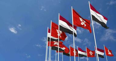 Hong kong und Jemen Flaggen winken zusammen im das Himmel, nahtlos Schleife im Wind, Raum auf links Seite zum Design oder Information, 3d Rendern video