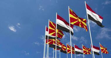 North Macedonia and Yemen Flags Waving Together in the Sky, Seamless Loop in Wind, Space on Left Side for Design or Information, 3D Rendering video