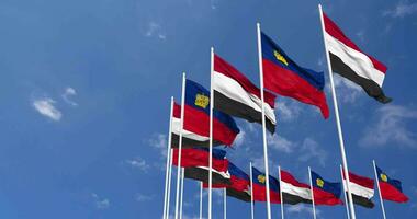 Liechtenstein and Yemen Flags Waving Together in the Sky, Seamless Loop in Wind, Space on Left Side for Design or Information, 3D Rendering video