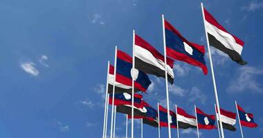 Laos and Yemen Flags Waving Together in the Sky, Seamless Loop in Wind, Space on Left Side for Design or Information, 3D Rendering video