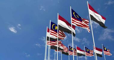 Malaysia and Yemen Flags Waving Together in the Sky, Seamless Loop in Wind, Space on Left Side for Design or Information, 3D Rendering video