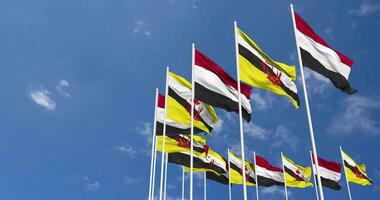 Brunei and Yemen Flags Waving Together in the Sky, Seamless Loop in Wind, Space on Left Side for Design or Information, 3D Rendering video