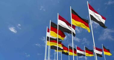 Alemanha e Iémen bandeiras acenando juntos dentro a céu, desatado ciclo dentro vento, espaço em esquerda lado para Projeto ou Informação, 3d Renderização video