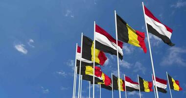 Belgium and Yemen Flags Waving Together in the Sky, Seamless Loop in Wind, Space on Left Side for Design or Information, 3D Rendering video