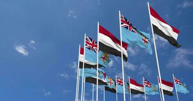 Fiji and Yemen Flags Waving Together in the Sky, Seamless Loop in Wind, Space on Left Side for Design or Information, 3D Rendering video