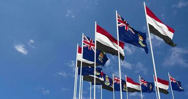 Cayman Islands and Yemen Flags Waving Together in the Sky, Seamless Loop in Wind, Space on Left Side for Design or Information, 3D Rendering video