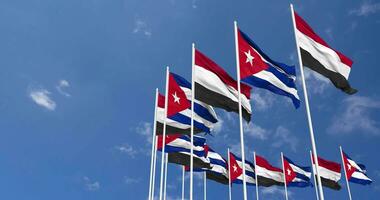 Cuba et Yémen drapeaux agitant ensemble dans le ciel, sans couture boucle dans vent, espace sur la gauche côté pour conception ou information, 3d le rendu video