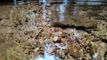 Serene Stream Flowing Over Rainbow Pebbles video