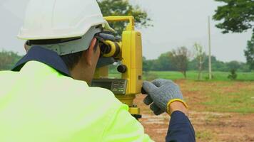 Surveyor engineer with equipment theodolite or total positioning station on the construction site. video