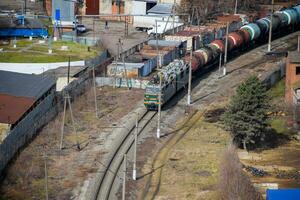 Freight train traveling through the city buildings. photo