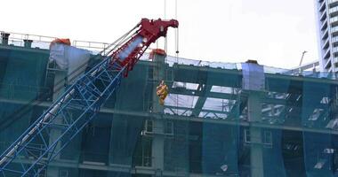 Moving cranes at the under construction in Tokyo telephoto shot video