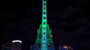 een nacht timelapse van roterend ferris wiel in yokohama breed schot zoom video