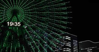 A night rotating ferris wheel at the urban city in Yokohama telephoto shot video