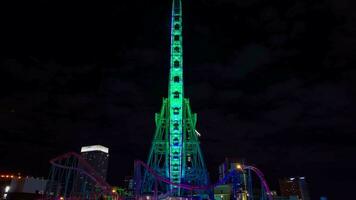 A night timelapse of rotating ferris wheel in Yokohama wide shot video