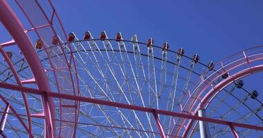 A rotating ferris wheel in Yokohama telephoto shot video