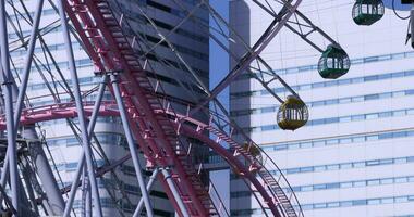 A rotating ferris wheel in Yokohama telephoto shot video