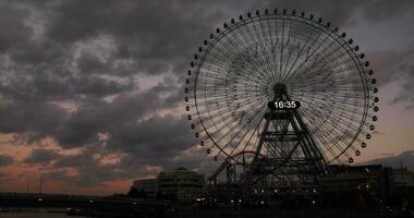 A dusk of rotating ferris wheel in Yokohama wide shot video