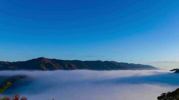 A timelapse of the sea of clouds at the top of the mountain in Kyoto wide shot panning video
