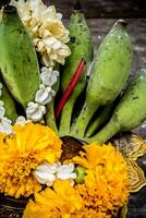 Banana and flower garland on pedestal tray photo