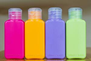 Small colored plastic bottles for traveling photo