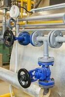 Pipes and faucet valves of heating system in a boiler room photo